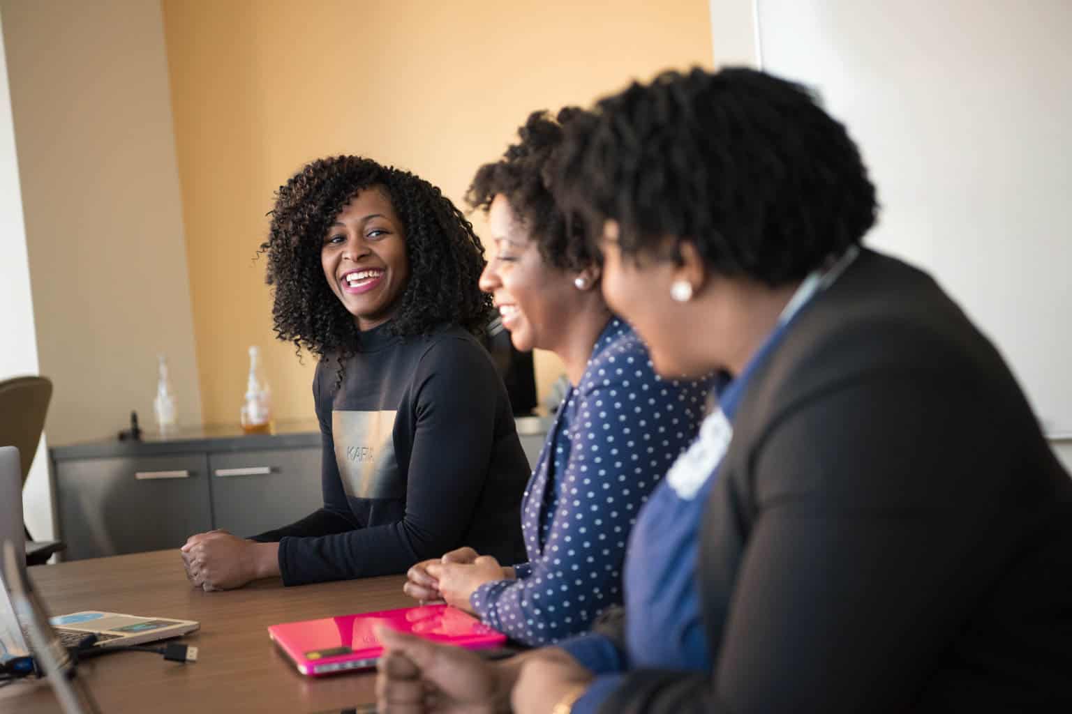 Black women taking at a table.