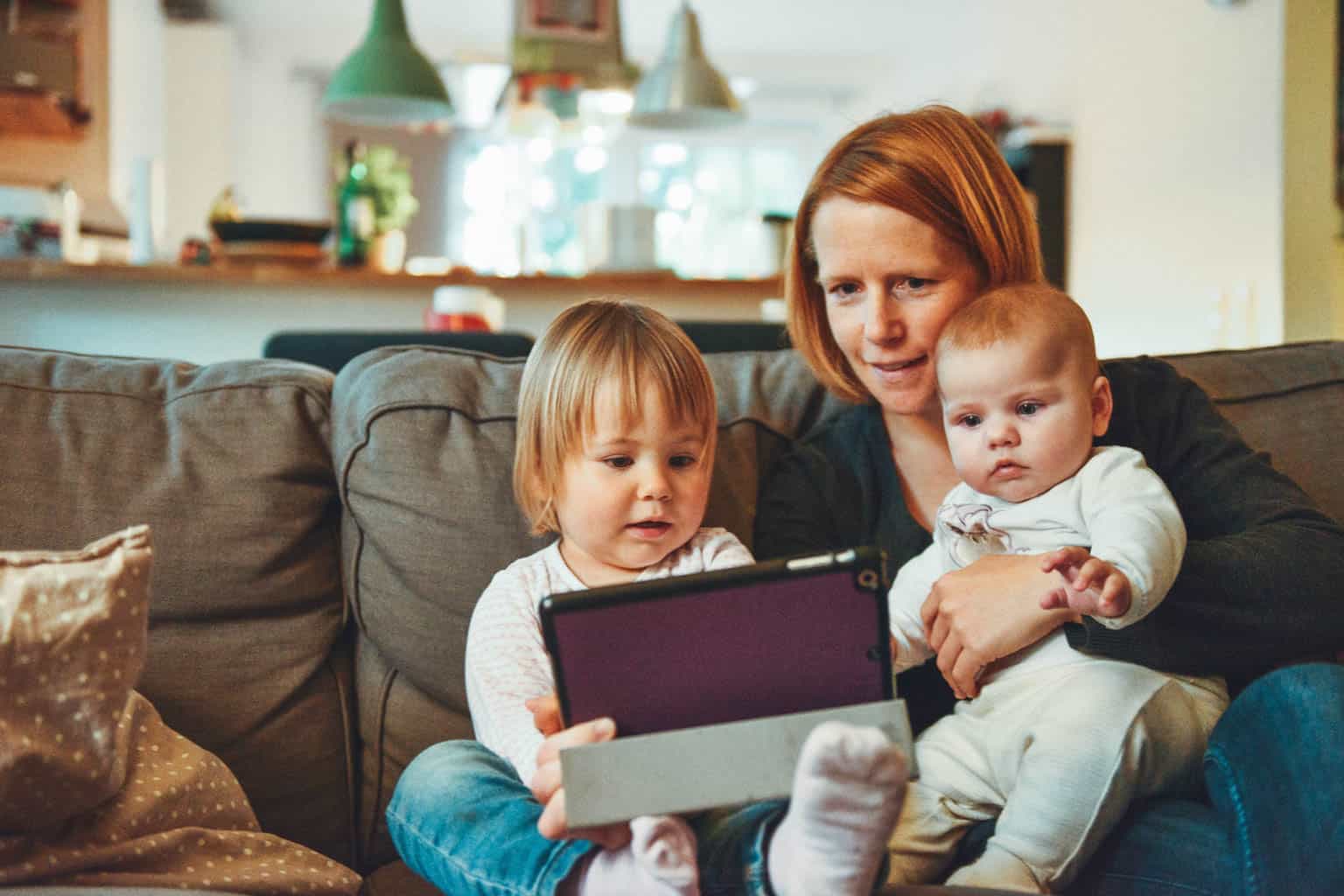 Woman sitting with her two children.